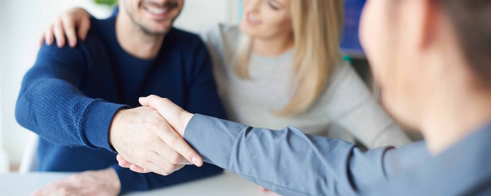 Man shaking hands with real estate agent Man shaking hands with real estate agent